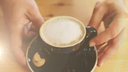 Poster - Animation of light spots over hands of caucasian man holding cup of coffee