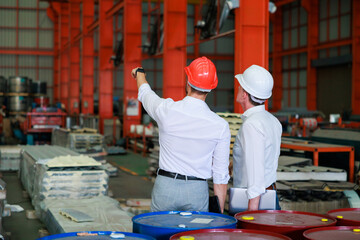 Sticker - back view and rear view young hispanic male worker wearing safety hard hat helmet inspecting metal raw materials for roofing warehouse