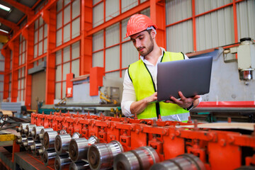 Wall Mural - lathe and stamping metal machine. Hispanic man and Factory engineer in hard hat helmet working on digital teblet computer at Heavy Industry Manufacturing Factory.