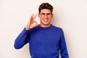 Young caucasian man isolated on white background cheerful and confident showing ok gesture.