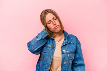 Wall Mural - Young caucasian woman isolated on pink background having a neck pain due to stress, massaging and touching it with hand.