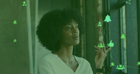 Sticker - Globe of digital icons spinning against portrait of african american woman smiling at office