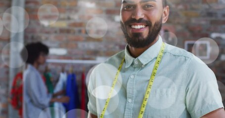 Poster - Video of spots of lights over biracial male tailor