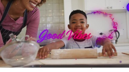 Wall Mural - Animation of good vibes text with african american mother and son baking together