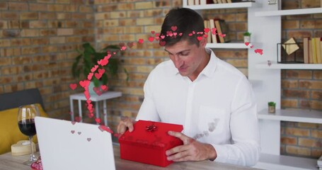 Poster - Animation of red hearts over caucasian man opening red gift box on video date