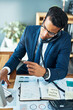 © K Seisa/peopleimages.com - Good afternoon, how may I help. Shot of a focused young businessman seated at his desk while taking on the phone and typing on a keyboard in the office.