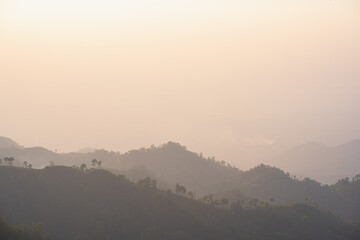 Canvas Print - silhouette and panorama layer of mountain with sunset background