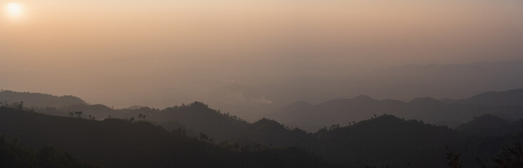 Canvas Print - silhouette and panorama layer of mountain with sunset background