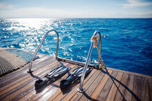 Diving With Scuba Gear And Flippers In Sea, Snorkeling Tour On Boat Yacht. Bright Photo With Sun Extreme Rest