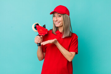 Wall Mural - senior gray hair woman smiling cheerfully, feeling happy and showing a concept. packer employee concept