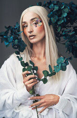 Wall Mural - Wrapped in beauty. Cropped portrait of an attractive young woman posing against a grey background in studio.