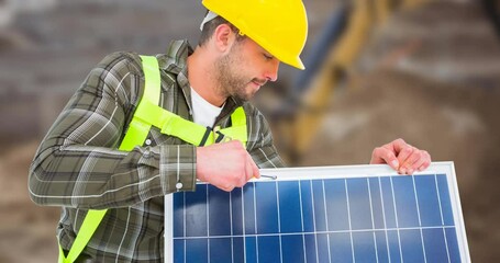 Poster - Animation of happy labor day text and stars over caucasian worker holding solar panel