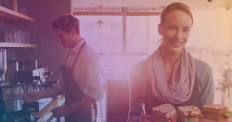 Poster - Animation of light spot over smiling caucasian female worker with sandwiches and colleague in cafe