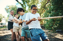 Were All Winning When Were Playing Together. Shot Of A Group Of Teenagers Playing A Game Of Tug Of War At Summer Camp.