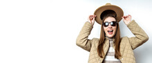 Smiling Young Woman In A Jacket Took Off Her Hat On The Background Of A White Wall. Banner.