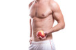 body of a young caucasian male athletic naked to the waist isolated on white background with an apple in hand