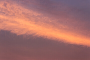 Wall Mural - glowing clouds on the red sky in evening light. dramatic weather in summer at dusk