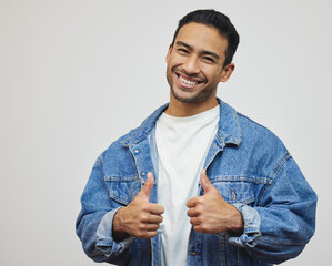 Poster - Two thumbs up for you. Cropped portrait of a handsome young man giving thumbs up in studio against a grey background.