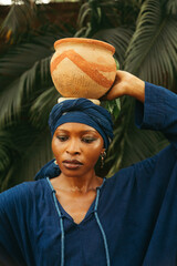 Wall Mural - beautiful black woman holding pottery in nature 