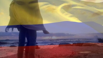 Wall Mural - Animation of flag of colombia over african american couple at beach