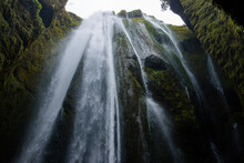 Dreamy Gljúfrafoss (Gljúfrabúi Waterfall) flowing into the dark cavern during a cloudy fall morning is Iceland.