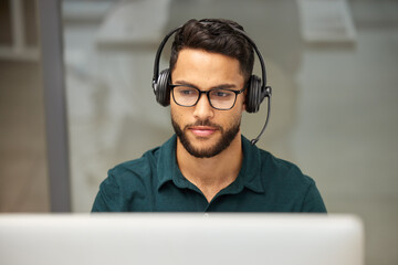Poster - Call us because your problem is our problem too. Shot of a businessman using a computer while working in a call center.
