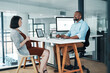 © Allistair/peopleimages.com - Great ideas come up in conversations. Cropped shot of two young businesspeople sitting in the office together and having a discussion.