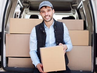 Aufkleber - On my way to drop-off the next box. Portrait of a young delivery man loading boxes from a van.