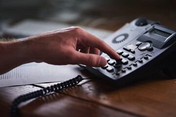 Fototapete - Success is a phonecall away. Shot of an unidentifiable businessman using a desk phone in the office.