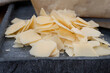 Flakes of parmesan cheese, italian hard parmigiano-reggiano cheese from Reggio Emilia region