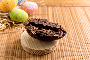 Wall Mural - Chocolate filled easter eggs on easter wooden background, easter concept