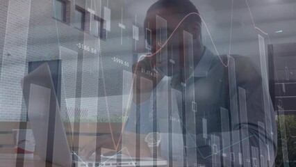 Poster - Animation of financial data and graphs moving over african american man using smartphone and laptop