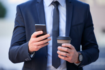 Canvas Print - Thanks to technology, youre never far from the office. Cropped shot of an unrecognizable businessman texting while standing outside in the city.