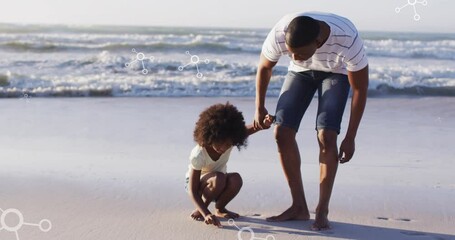 Sticker - Animation of molecules over african american afather and son picking up shells on beach at sunset