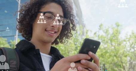Poster - Animation of user icons over happy biracial man using smartphone in city