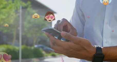 Poster - Animation of emoticons over hands of biracial man using smartphone in city