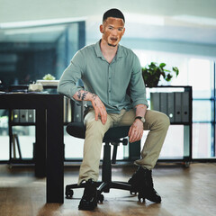 Fototapete - Im on the path to success. Shot of a young businessman sitting at a desk in an office at work.