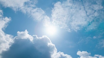 low angle timelapse bright sun on blue summer sky with moving fluffy clouds, sun shining sunbeams, w
