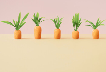 Wall Mural - Carrots on pastel yellow and pink background . Spring minimal composition.Happy Easter. Creative minimal Easter holiday concept. Spring holiday Easter celebration greeting card or idea.