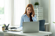 © PaeGAG - Asian businesswoman in formal suit in office happy and cheerful during using smartphone and working