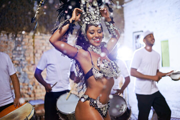 Wall Mural - In fine feather. Shot of an attractive female Mardi Gras dancer in an elaborate beaded costume and feather headdress.