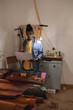© Wavebreak Media - African american young craftsman using laptop while standing against wall in leather workshop