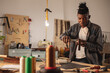© Wavebreak Media - African american young craftsman punching leather belt with punch plier while working in workshop