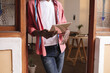 © Wavebreak Media - Midsection of african american young male owner with digital tablet standing at store entrance