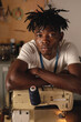 © Wavebreak Media - Close-up portrait of african american young craftsman with arms crossed on sewing machine