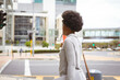 © Wavebreak Media - African american mid adult businesswoman having drink while walking on road in city