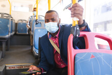 African American Businessman Holding A Smartphone While Sitting In The Bus On The Go To Office