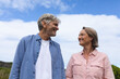 © Wavebreak Media - Cheerful caucasian mature couple looking at each other while standing against sky