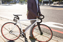 African American Businessman With Bicycle Walking On The Street On The Go To Office