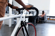 Cropped Image Of Businesswoman With Bicycle In Creative Office